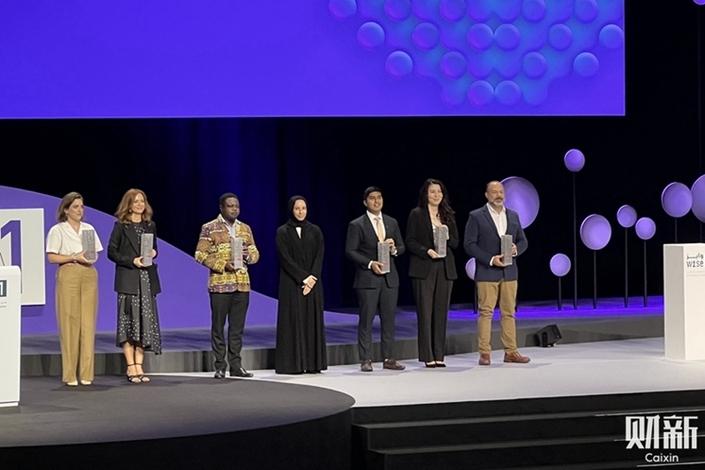 Winners of the WISE Education Innovation Project Awards gather on stage on Nov. 28. Photo: Hu Xuan/Caixin